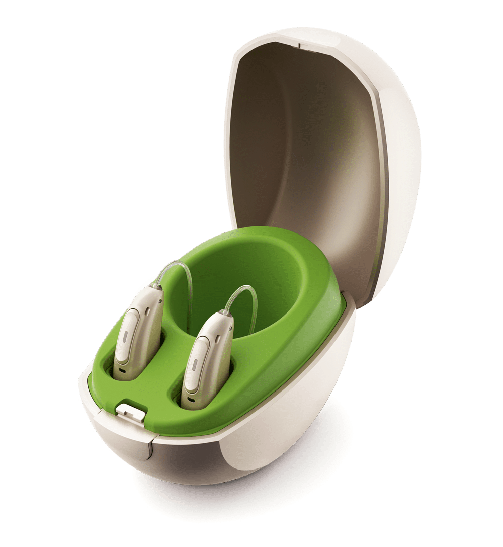 A set of hearing aids in a charging cradle
