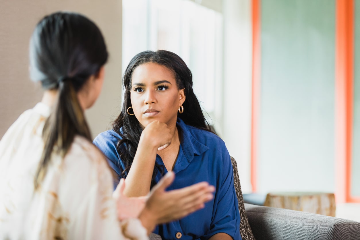 Woman listening intently to her friends.